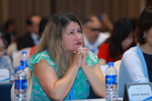 Debi Boeras listening to a speaker at the EMTCT workshop in Shenzhen, China